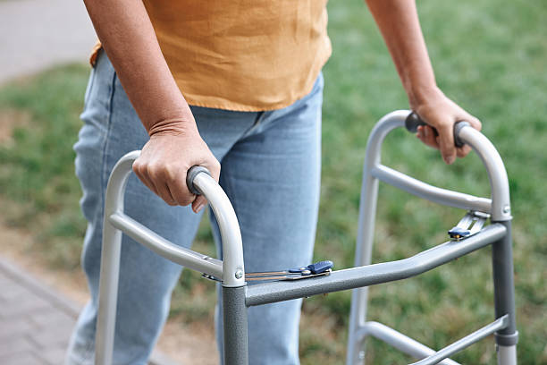 istock Senior woman with walking frame in park, closeup 2212385227