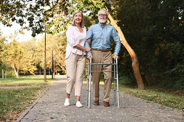 istock Senior couple with walking frame in park 2212385288