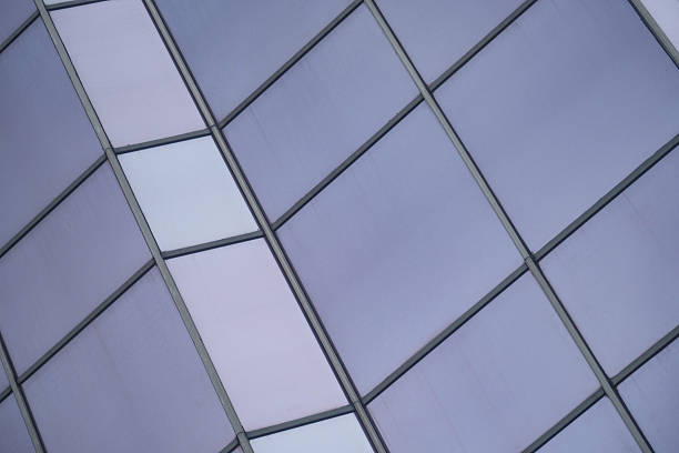 A modern and sleek facade of a contemporary office building showcasing large glass windows