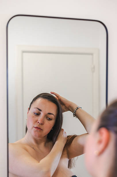 istock Woman Combing Hair - Daily Beauty Routine 2212386975