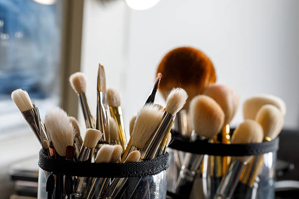 istock Makeup brushes in a leather pouch, various sizes and shapes, ready for use. A mix of bristles poking out. 2212391424
