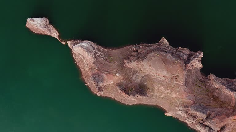 Rocky island in the middle of the lake in Valle Grande, Mendoza, Argentina. Aerial view.