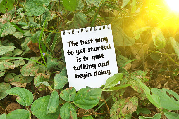 istock Notebook with quote 'The best way to get started is to quit talking and begin doing' on forest ground 2212396775