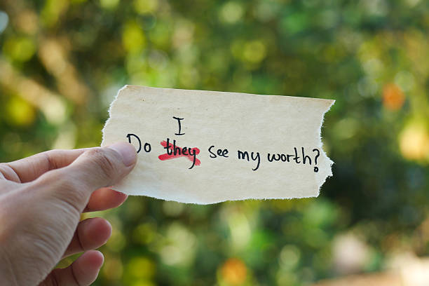 istock hand holding a note paper with the words Do They See My Worth? replacing Do I See My Worth? Self-Reflection, Identity, Empowerment, Emotional Growth, Mental Health Journey 2212397103