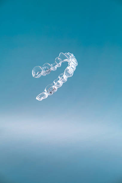 istock Invisible aligners for dental correction on blue background. 2212397190