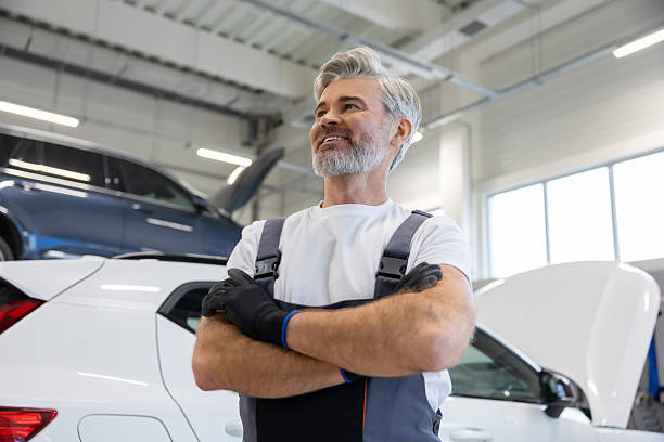 istock Mechanic standing in service area 2212398398