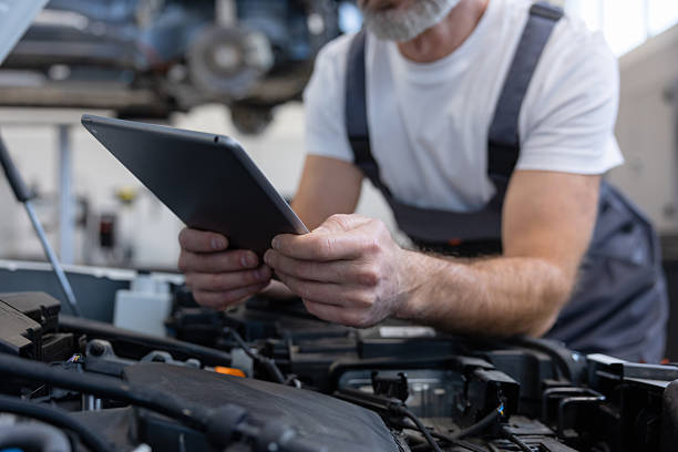 istock Mechanic with tablet in auto repair workshop 2212398599