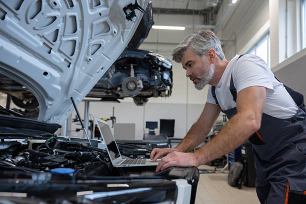 istock Mechanic with laptop in auto repair workshop 2212398615
