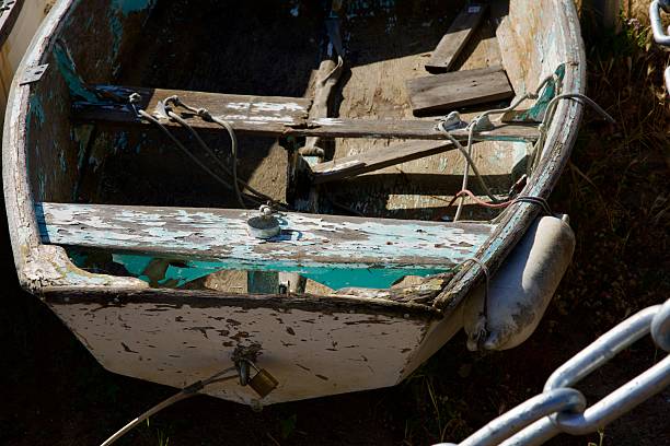 istock Unseaworthy wooden rowboat with peeling paint 2212398730