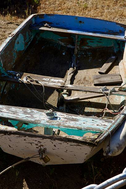 istock Unseaworthy wooden rowboat with peeling paint 2212398744