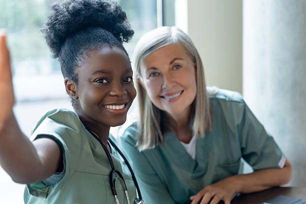 istock Two doctors colleagues making selfie together and looking contented 2212399300