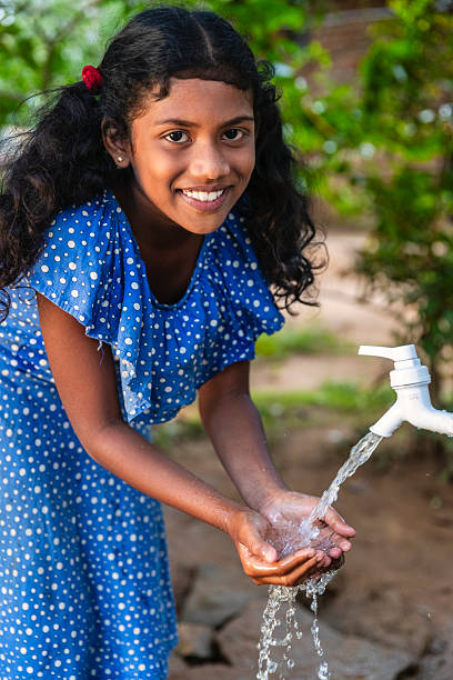 istock Sri Lankan young girl drinking a water, Ceylon 2212399948