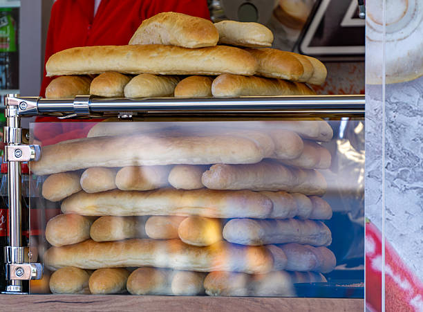 istock A stack of fresh rolls and baguettes displayed in a glass case at a bakery stand 2212400592