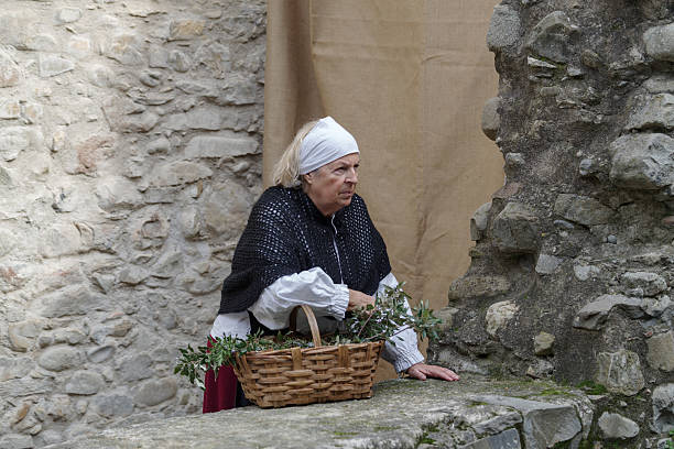 Taggia, Italy - February 23, 2025: Close-up of participant the historical reenactment in the historic city of Taggia, Liguria region of ItalyFor more than 40 years, the last Sunday of February in the old town of Taggia, concludes the feast of St. Benedict, with a great display of historical commemoration. Celebrations San Benedetto is a historical reenactment the most important in Liguria region of Italy. The districts of Taggia set in some areas most characteristic historical paintings, that show us moments of life, that was lived in seventeenth century. The incidents depicted are inspired by the events actually took place, drawn from the documents kept in the historical archives. (Province of Imperia, Italy)