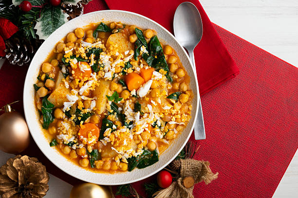 istock Spinach, potato and chickpea stew with egg. Top view table with christmas decorations. 2212403208