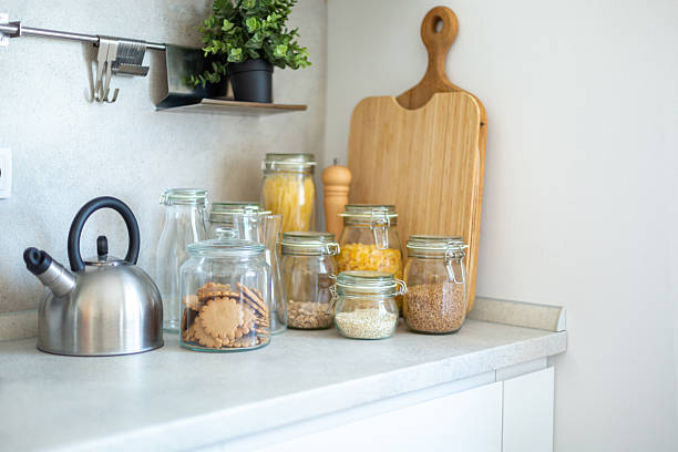 istock Modern kitchen countertop with kettle and food storage jars displaying a minimalist and organized cooking space 2212403260