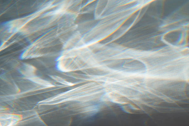 istock Abstract background. Water texture shadow with rainbow refraction of light. Overlay effect 2212403759
