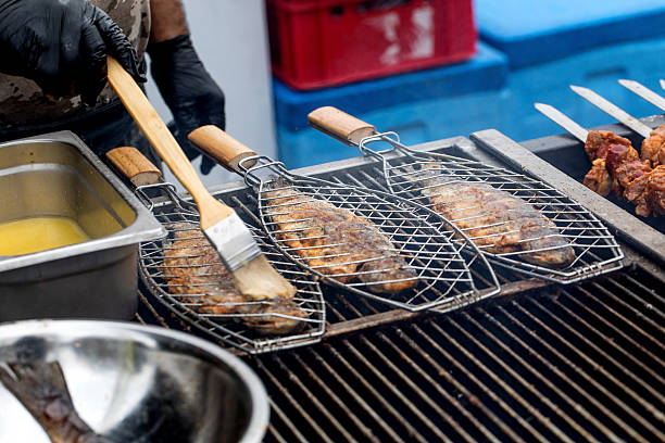 istock Grilling Fish on Barbecue Grill Baskets 2212404432