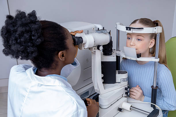 istock Ophthalmologist checking girls vision by using optical medical equipment 2212404974