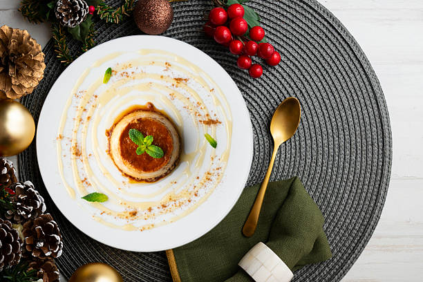 istock Egg flan with homemade Spanish recipe. Top view table with christmas decorations. 2212406124