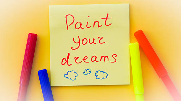 istock Colorful sticky note with a motivational phrase urging to color your day with joy 2212406435