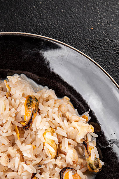istock Seafood rice risotto frut de mer mussels, shrimp, prawn, rapan, squid vegetable dish fresh delicious gourmet food background on the table rustic food top view copy space 2212409217