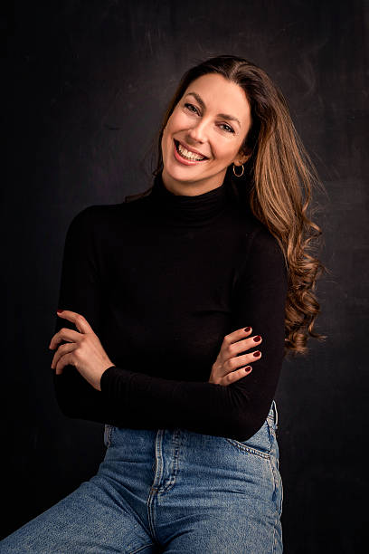 istock Carefree brown haired woman laughing against a dark background 2212410607