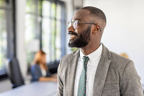 istock Businessman with glasses smiling in stylish office space 2212410925