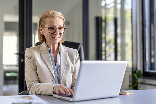 istock Professional woman working on a laptop in modern office 2212411035