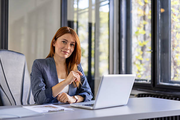 istock Confident businesswoman in a modern office setting 2212411036