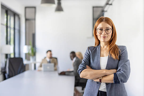 istock Confident businesswoman poses in modern office setting 2212411040