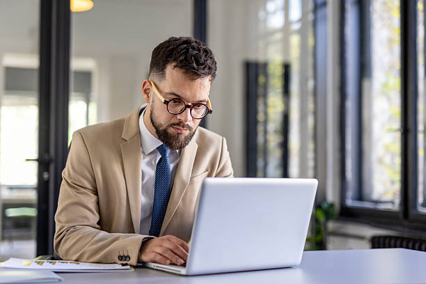 istock Focused professional typing on laptop in modern office space 2212411042
