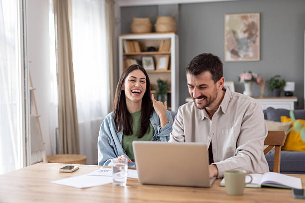 istock Cheerful couple enjoying time together at home office setup 2212411528