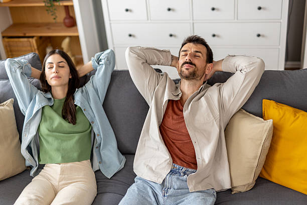 istock Couple Relishing Leisure Time on a Comfortable Sofa 2212411529