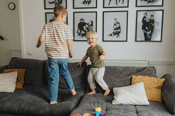 istock Cheerful brothers having fun at home 2212412257