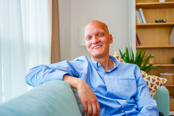 istock Smiling cancer Man Relaxing at Home on a Sofa 2212414731
