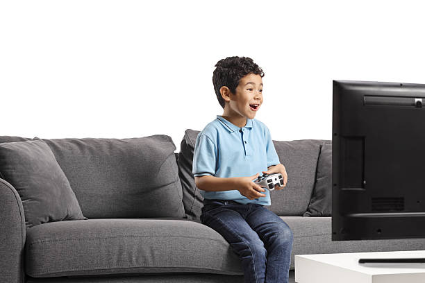 istock Excited asian kid sitting on a sofa and playing video games 2212415535