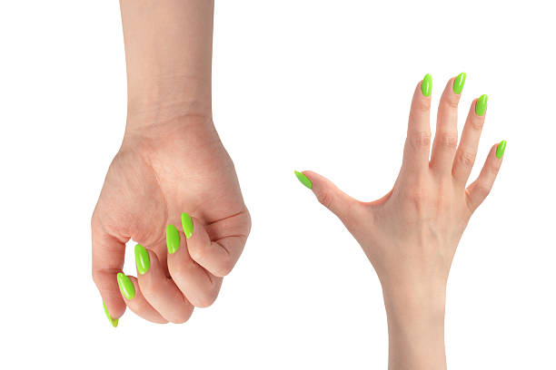 istock Hand of a woman with green naols hold some tiny or thin object. 2212416751