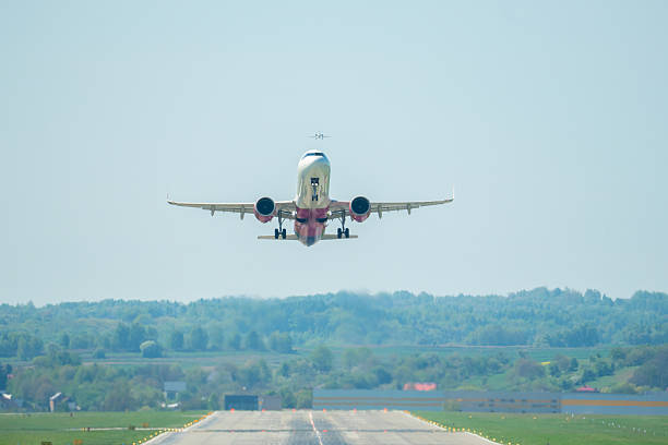 istock Passengers experience the thrill of takeoff as a plane ascends into the clear blue sky above lush green landscapes 2212417397