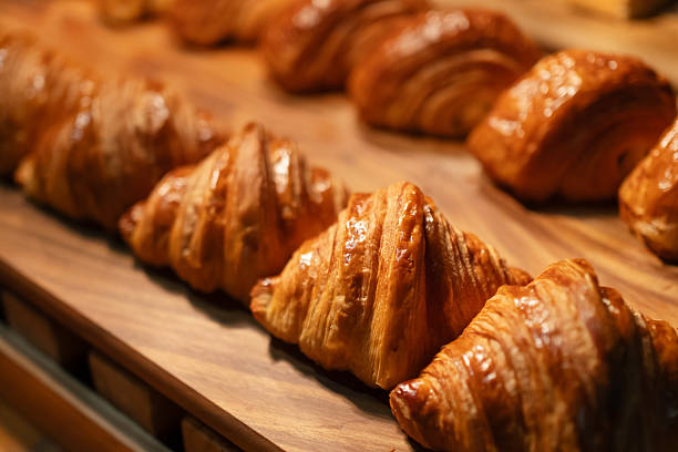 istock Freshly baked golden croissants ready on a tray for a buffet breakfast. 2212417843