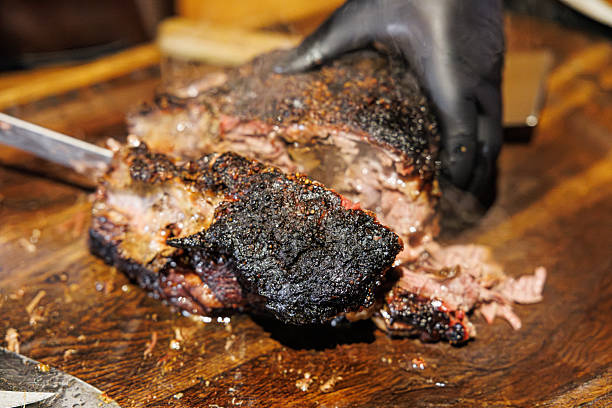 istock Precision Slicing of Smoked Meat for a Savory Feast 2212418672
