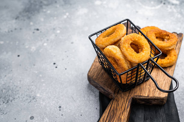 istock Deep Fried crunchy onion rings, delicious snack. grey background. top view 2212418742