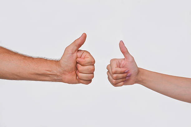 istock A man's and a woman's hand shows a thumb up gesture. isolated on a white background 2212419921