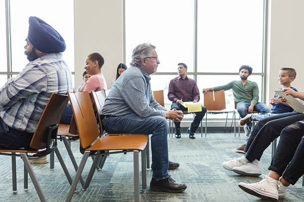 istock Multiracial Group Therapy Session: Diverse People Talking and Listening 2212420165