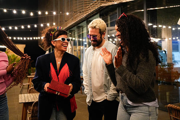 istock Multiethnic friends celebrating birthday party at night 2212421885