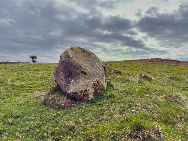 istock Solitary Boulder in Wide Open Landscape Under Moody Sky 2212422131