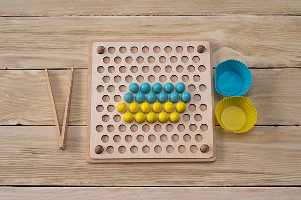 sorting board - games with colorful balls. The game is based on the Montessori system.