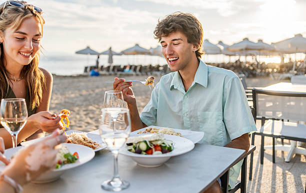 istock Friends enjoying a meal at a beach restaurant 2212426805