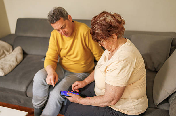 istock Mom and Son Browsing Phone Together 2212427300