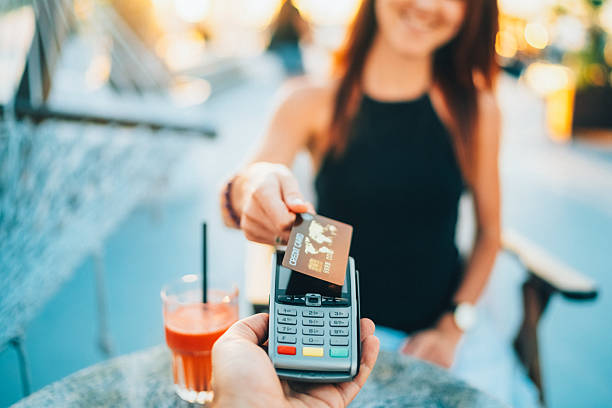 istock Woman in cafe making cotactless payment for drinks 2212428546